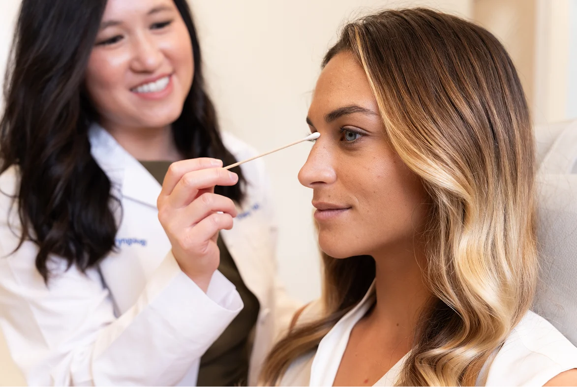 Doctor Tiffany Pham MD consulting with female patient about facial aesthetic treatment in medical office - Nose in San Diego, CA.