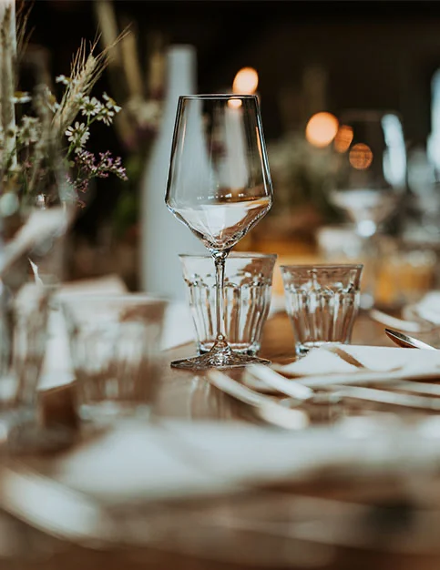 Elegant restaurant table setting with wine glasses and soft bokeh lighting for dining out - out of town in San Diego, CA